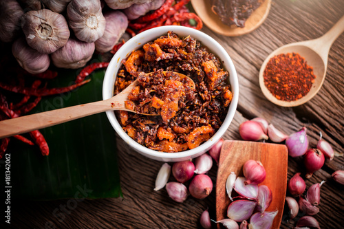 thai tradition style spicy dipping mad frop pork and shirmp with spicy and herb for ingredient on wooden texture table photo