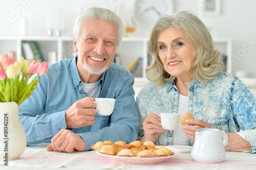 senior couple drinking tea with cookies