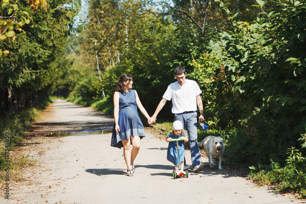happy family with pet dog at picnic in a Sunny summer day. pregn happy family with pet dog at picnic in a Sunny summer day. pregn