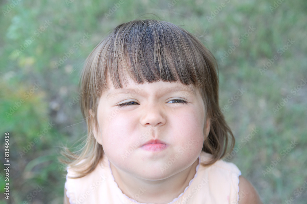 Little girl wrinkle nose making funny face portrait from above Little girl wrinkle nose making funny face portrait from above