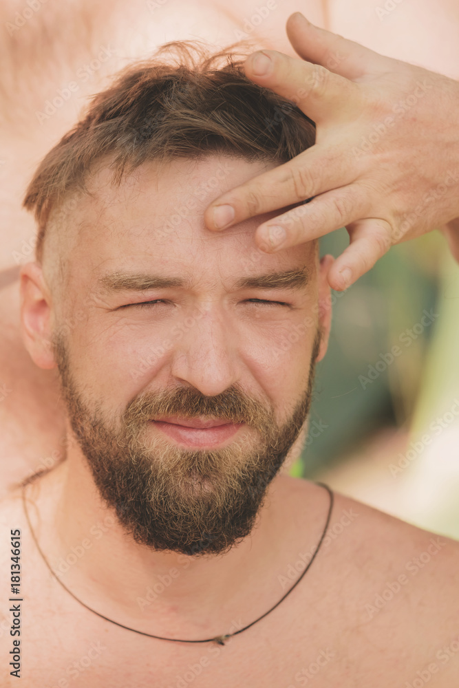 Obraz premium Young handsome man at the time of creation hairstyle