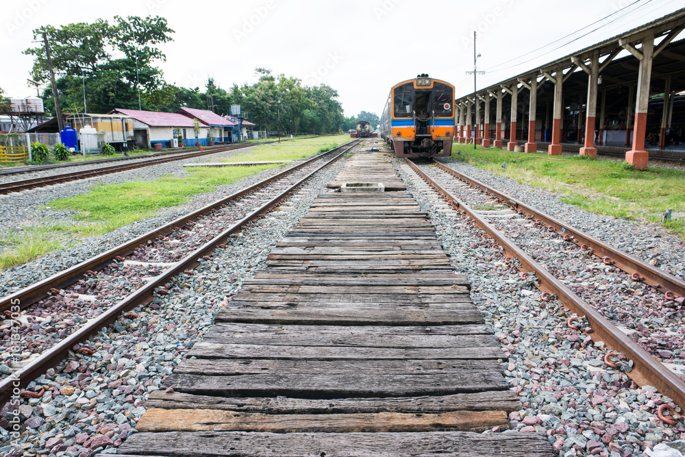 Sleeper train wood with railroad tracks and old train in Thailand