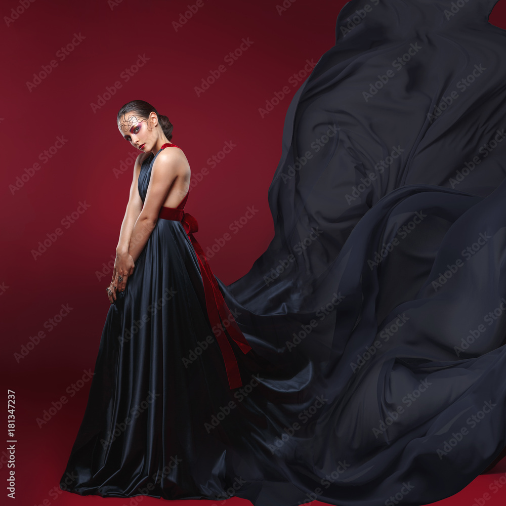 Naklejka premium beautiful woman in flying silk dress