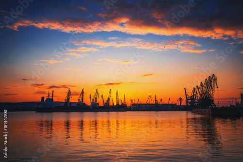 Sunset over sea port and industrial cranes  Varna
