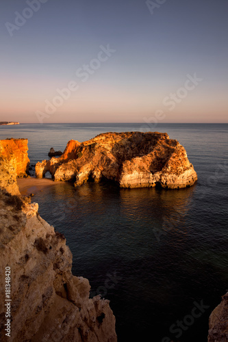 The cliffs of Algarve region in Portugal painted by the warm evening sun