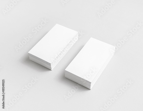 Photo of blank white paper business cards with soft shadows. Mock up for branding identity for designers.