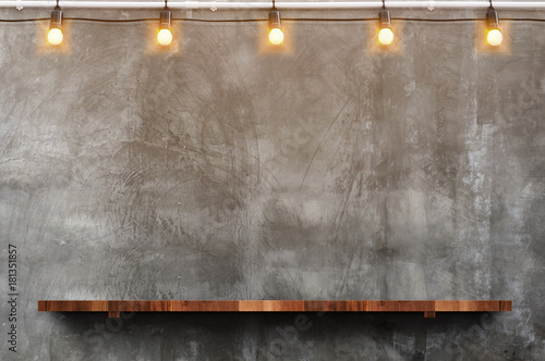 Fotótapéta Empty brown wood plank board shelf at grunge concrete wall with light bulb strin