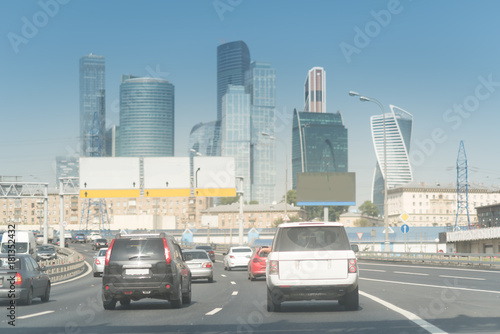 Skyscraper road with many cars. Traffic on a city road