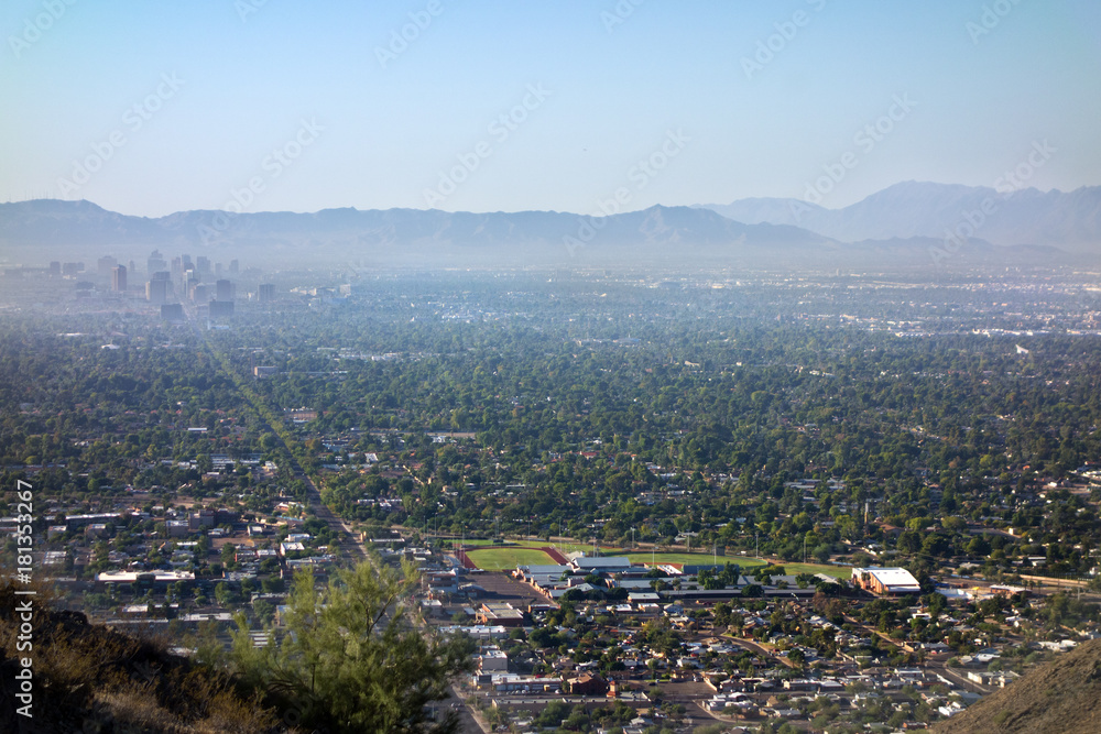 Air pollution from Interstate-10 and I-17 in morning haze above major Arizona city downtown of Phoenix as seen from the top of North Mountain Park hiking trails