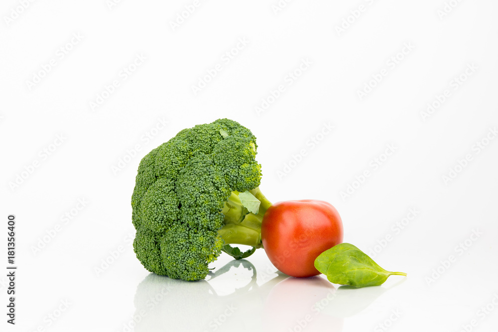 Broccoli And Tomato On White Background With Reflection Broccoli And Tomato On White Background With Reflection