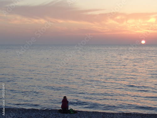 Watching sunset at the sea coast