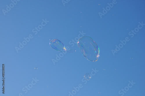 Two bubbles from the bubble blower floating on the sky