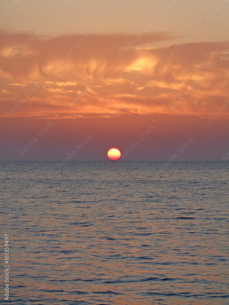 Marine sunset, sun go down in the sea, colorful sky
