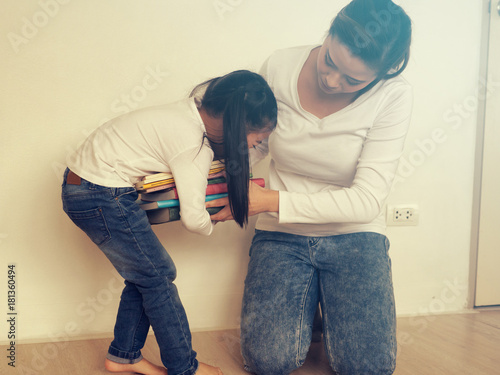 Asian Schoolgirl holding book at home for ready to go to school.Back to school concept. photo