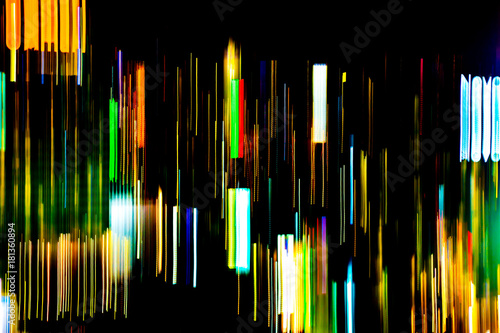 Abstract of multicolored city lights beams in motion  Moving colorful lines or light painting LED building abstraction on busy city Light trails  Rainbow and chaos black background. Vertical desigh