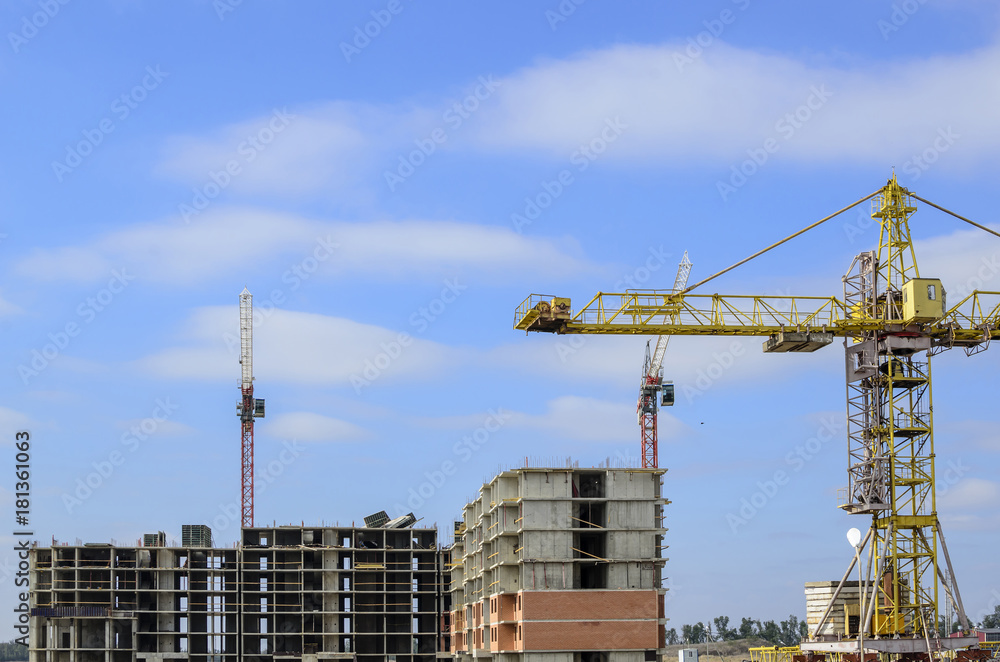 Three construction cranes in the construction site. Three construction cranes in the construction site.