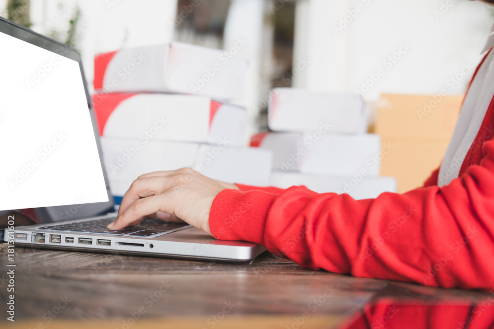 startup small business owner check product order with computer at workplace. freelance woman seller prepare parcel box for deliver to customer. Online selling, e-commerce, shipping concept startup small business owner check product order with computer at workplace. freelance woman seller prepare parcel box for deliver to customer. Online selling, e-commerce, shipping concept