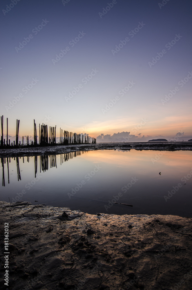 Obraz premium sunrise light on the beach with muddy wave , clay wave