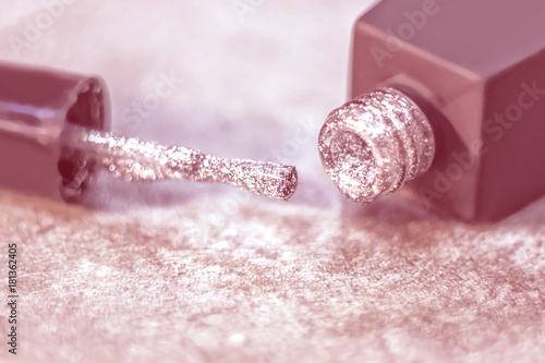 Texture of shiny nail polish shine closeup.a bottle of nail polish next to the brush. The concept of cosmetic photo