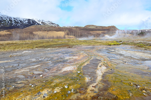 Beautiful landscape with minteral deposits and steaming geysers photo