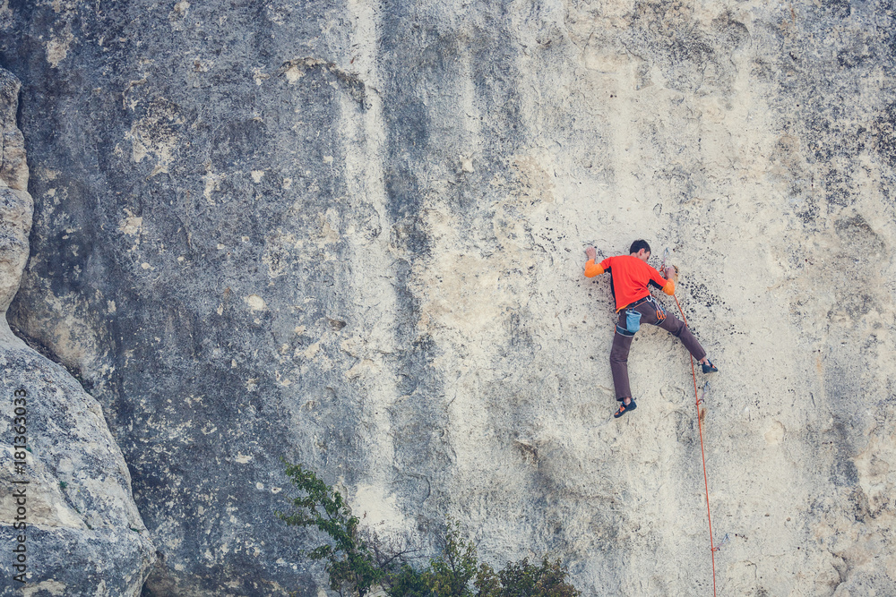 Naklejka premium A man climbs the rock.