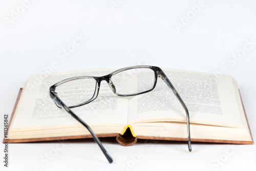 Glasses open book white background