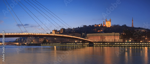 Panorama of footbridge ’Passerelle Palais du Justice’ over the Saone river in Lyon during twilight.