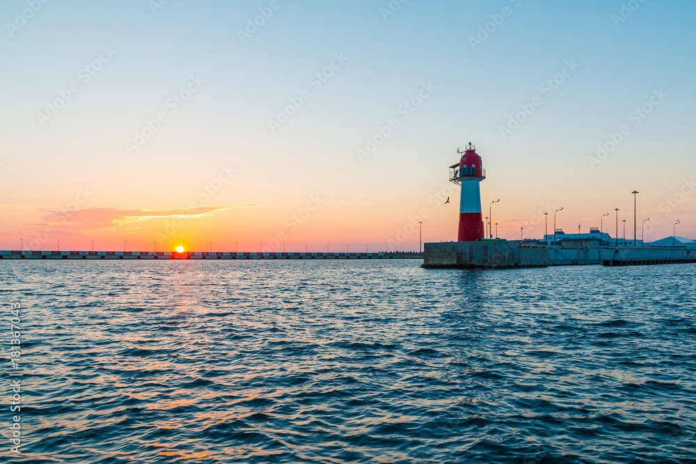 Sunset over the Northern mole with the lighthouse, Sochi, Russia
