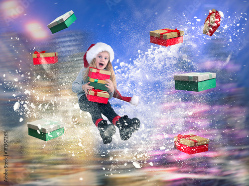 Happy girl flying in a snowstorm among the many gifts. The concept of the Christmas discounts and sales