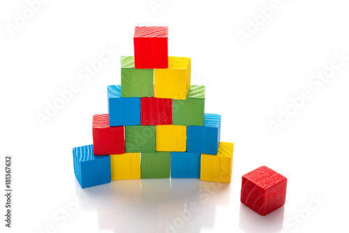 colorful wooden toy blocks stack up on a white background