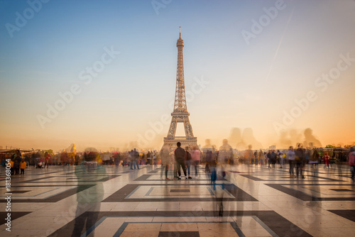 Blurred people on Trocadero square admiring the Eiffel tower at sunset, Paris, France