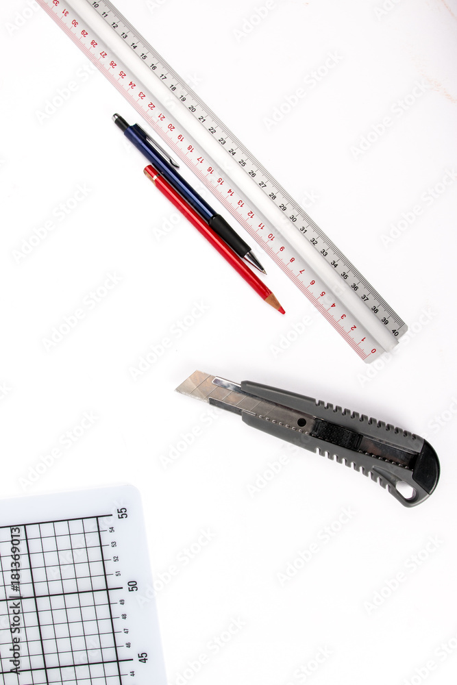 Graphic designer tools. Atelier equipment. Box cutter, cutting mat, pencil and ruler. Art Concept. Top view. Copy space. Graphic designer tools. Atelier equipment. Box cutter, cutting mat, pencil and ruler. Art Concept. Top view. Copy space.