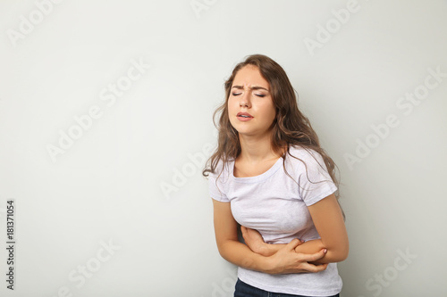 Young woman having stomach ache