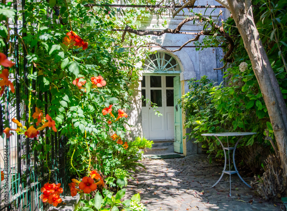 Entrance courtyard with flowers and garden furniture Entrance courtyard with flowers and garden furniture