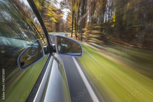 Car driving on a street in autumn © pwmotion