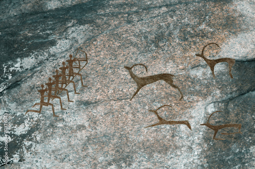 Drawings in the cave. Prehistoric people hunt animals. Caveman  Neanderthal  primitive  aboriginal. The Stone Age.