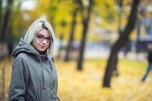 Beautiful hipster girl with glasses in autumn