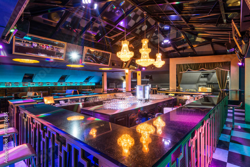 Interior design of discotheque with luxury chandeliers above bar counter photo