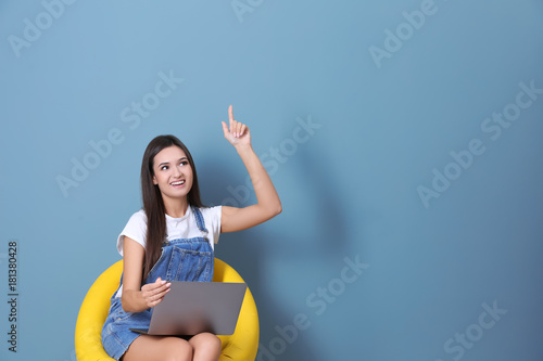 Young woman with laptop in ...