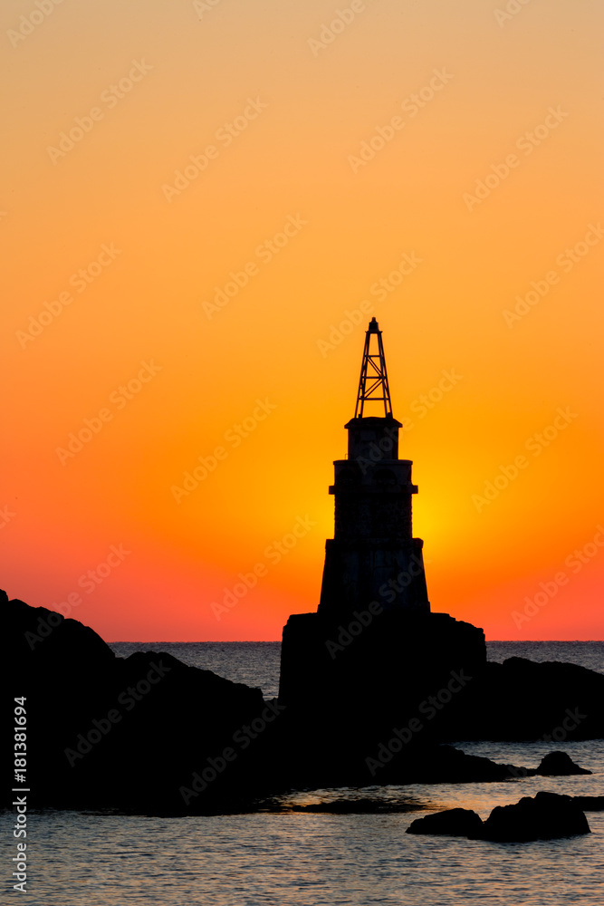 The Sun is hiding behind the Ahtopol lighthouse in Bulgaria