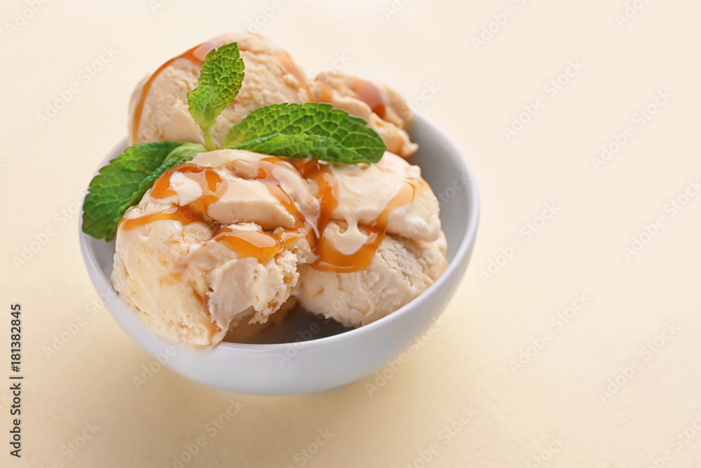 Bowl with caramel ice cream on light background Bowl with caramel ice cream on light background