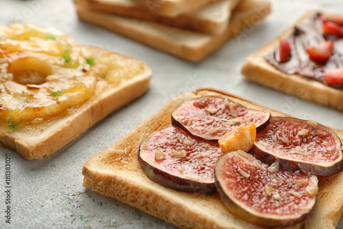 Delicious toast with fig on table, closeup