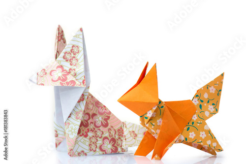 Two origami foxes. Cute designed paper figurines of animals. Folding paper with fun and creative.