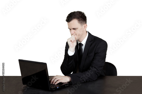 Pensive Caucasian businessman with laptop