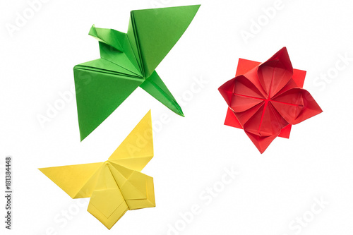 Crane, butterfly and lotus origami on white. Red, green and yellow paper. Hand crafting project idea for kids. © DenisProduction.com