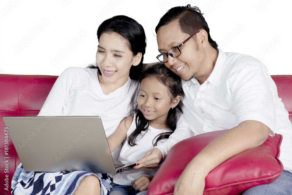 Little girl and parents with laptop Little girl and parents with laptop