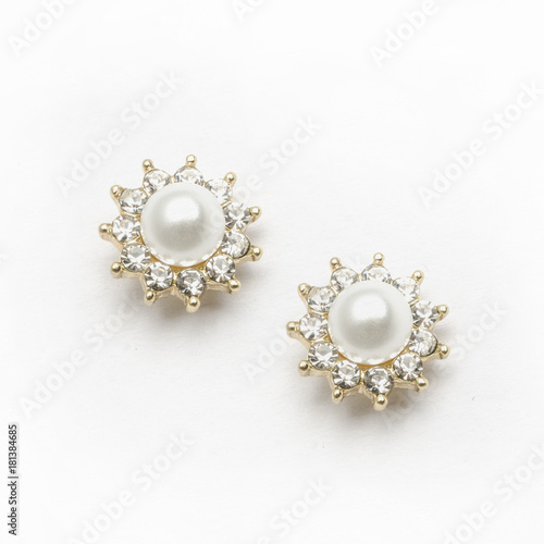 Earrings with pearls and diamonds on white background