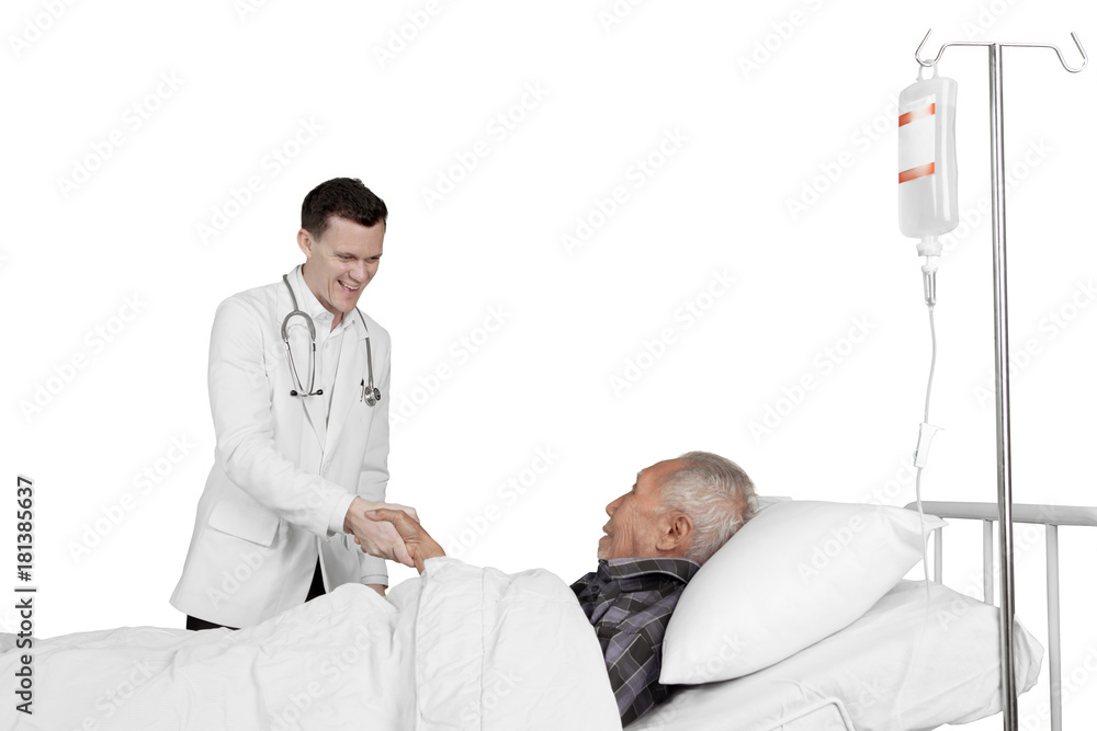Fototapeta premium Doctor shaking hand with elderly patient