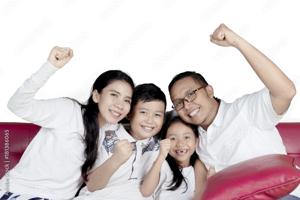 Cheerful family raise hands on sofa Cheerful family raise hands on sofa