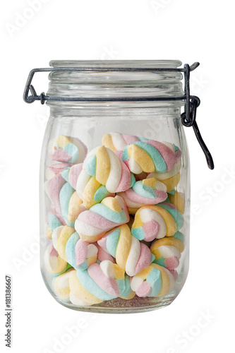 multicolored twisted marsmallows stacked in a jar isolated on white background photo